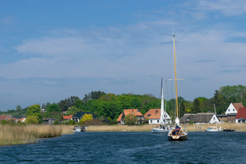 Fototapeta na wymiar sailboat in the bay - boat at the entrance of a marina