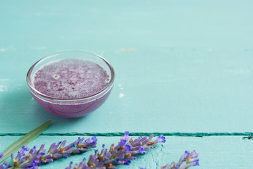 cup of lavender tea with a pile of fresh flowers, syrup, bunch, on blue wood table background