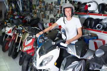 Fototapeta na wymiar Adult man in helmet is sitting on motorbike