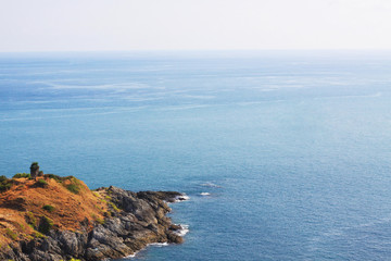 Beautiful seascape with sky twilight of sunset and sea horizon with Calm and blue sky.Dry grass field on mountain of Phrom Thep Cape is famous place in Phuket island, Thailand.