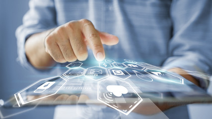 hand presses social media icons on screen digital tablet