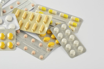 Group of multi colored pills, capsule on white background