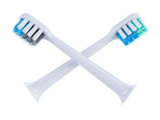 Two removable heads for electric brush with bristles of different colors located cross.