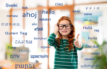 education, translation and learning concept - smiling red haired student girl in glasses and green...