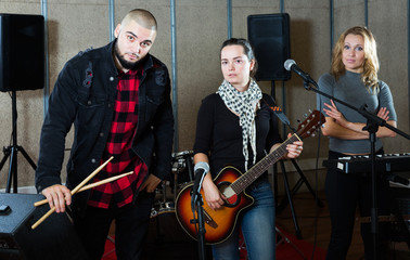Fototapeta premium group of rock musicians posing with instruments