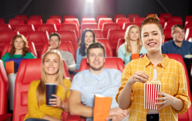 cinema, fast food and entertainment concept - smiling red haired teenage girl in checkered shirt...