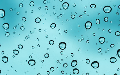 Blue background, Natural water drop on glass.