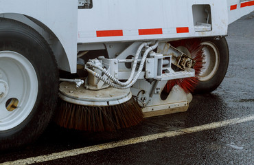 A street sweeper machine cleaning in the road cleaning asphalt