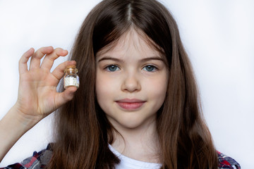 girl holding a jar with homeopathic medicine