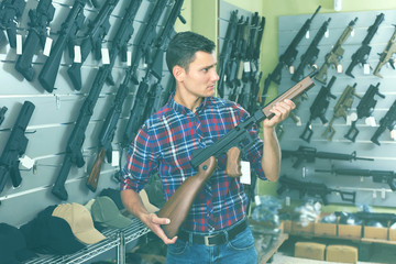 Male is choosing air-powered gun