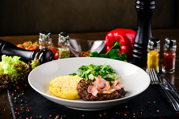 beef steak and bacon in a plate