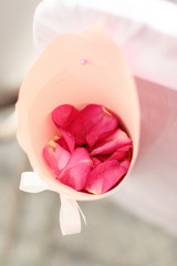 Beautiful Pink Rose petals Flowers decorated on white chair in wedding ceremony