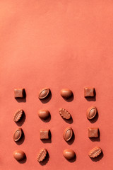 Chocolate candy on brown background. World Chocolate Day. Place for text.