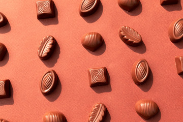 Chocolate candy on brown background. World Chocolate Day.