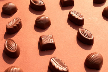 Chocolate candy on brown background. World Chocolate Day.