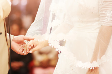 Bride ant groom holding hands and walking together.