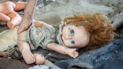 Dirty old doll in an abandoned house in Chernobyl exclusion zone in Belarus