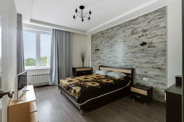 Modern interior of ecological master bedroom in natural tones.