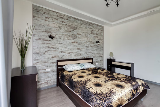Modern interior of ecological master bedroom in natural tones and textile art.