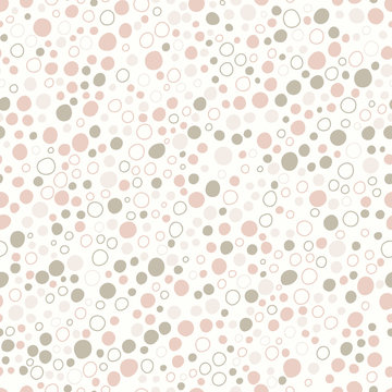 Seamless pattern of pebbles and hollow circles on a cream background.