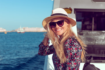 Happy traveler woman toothy smile on cruise ship on Mediterranean sea