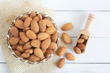Almonds nuts in wooden bowl on wood table,Top view.