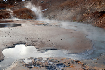 Geothermal alternative energy concept. Seltun geothermal area in Iceland. Bubbling mud pools and steaming hot springs.