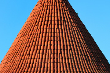 Red tiled conical roof of a tower