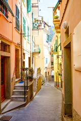 Obraz premium Riomaggiore, Liguria, Italy fisherman village, colorful houses on sunny warm day. Monterosso al Mare, Vernazza, Corniglia, Manarola, and Riomaggiore, Cinque Terre National Park UNESCO World Heritage