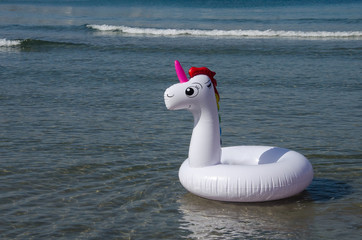 Unicorn swim tube floating on the sea
