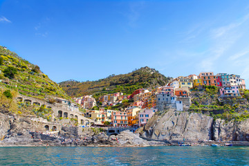 Manarola, Liguria, Italy fisherman village, colorful houses on sunny warm day. Monterosso al Mare, Vernazza, Corniglia, Manarola and Riomaggiore, Cinque Terre National Park UNESCO World Heritage