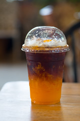 Orange juice espresso with ice. Ice cold summer drink.