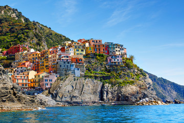 Fototapeta na wymiar Manarola, Liguria, Italy fisherman village, colorful houses on sunny warm day. Monterosso al Mare, Vernazza, Corniglia, Manarola and Riomaggiore, Cinque Terre National Park UNESCO World Heritage