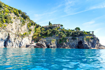 Naklejka premium Liguria, Italy coastline of Riviera with colorful houses on sunny warm day. Monterosso al Mare, Vernazza, Corniglia, Manarola and Riomaggiore, Cinque Terre National Park UNESCO World Heritage
