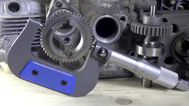 Industrial still life a micrometer against the background of details of cars and mechanisms.Dolly shot