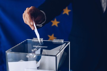 Male inserting his vote to ballot box