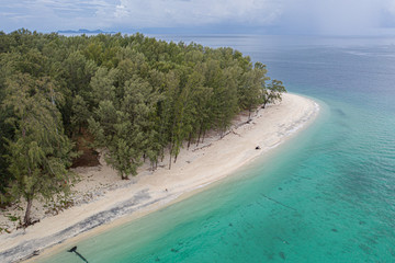 Aerial drone view of the beautiful lagoon sea surface and tropical paradise island with white sand