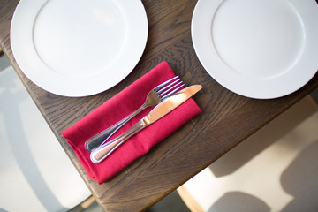 Table setting with fork, knife and red napkin