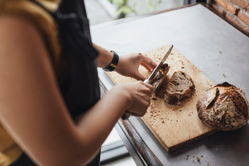 Woman Cutting a Bread