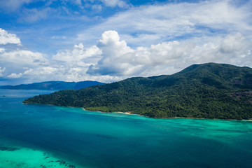 Aerial drone view of beautiful green Koh Usen island with amazing lagoon sea over summer sky background, Thailand