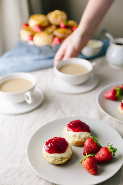 Devonshire style afternoon tea with cream then jam with woman se