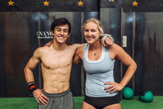 Cheerful athletes standing in gym