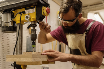 Carpenter operating drilling machine