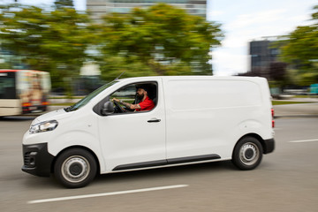 Side view of cargo car driving on road.