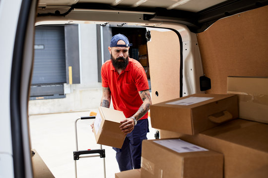 Man loading packages into the car.