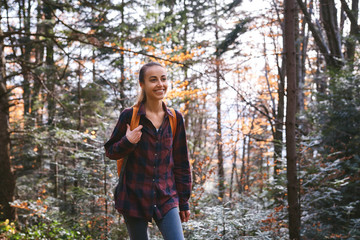 Portrait of a woman hiker walking on the trail in the woods.
