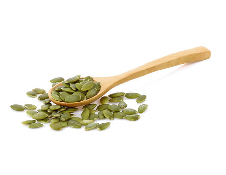  Pumpkin seeds in wooden spoon isolated on white background