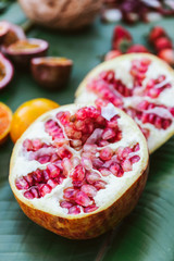Cut half fresh Pomegranate fruit on banana leaves. Example taste of coffee. Fruity and Sour.