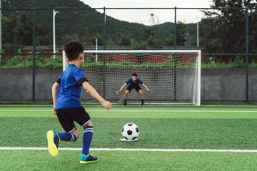 Father and son playing soccer