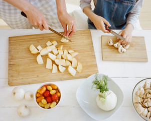 Crop shot. Mother and daughter cutting vegetables